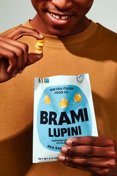 a man holding up a box of brand lupin