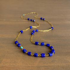 Opulently timeless, this sublime lapis and gold chain can be worn as a single strand, doubled up, or circled around the wrist as a wrap bracelet. 22k yellow gold Lapis 8mm x 7mm (1/4" x 1/4")Turquoise accents approx. 4mm (3/16") in diameterNecklace is 33.5" long Blue Lariat Jewelry With Adjustable Chain, Elegant Blue Jewelry With Beaded Chain, Elegant Blue Beaded Chain Jewelry, Elegant Lapis Lazuli Jewelry With Adjustable Chain, Elegant Blue Chain Jewelry, Elegant Blue Jewelry Chain, Blue Oval Link Necklaces For Gift, Blue Oval Link Necklace For Gift, Blue Double Strand Natural Stones Jewelry