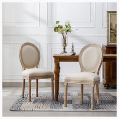 two chairs sitting next to each other in front of a table with flowers on it