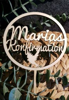 a wooden sign that says margas konffnanton on it in front of some leaves