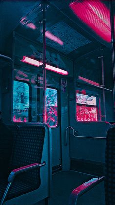 the inside of a bus with red and blue light coming from it's windows