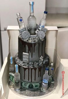 a three tiered cake decorated with liquor bottles and money