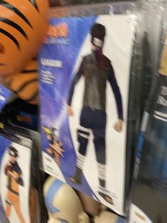 a tiger costume is on display in a store with other costumes and toys behind it