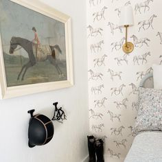 a bed room with a neatly made bed and a painting on the wall