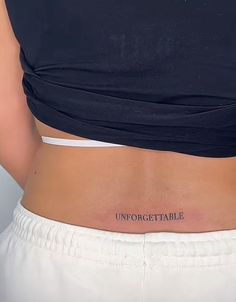 a woman's stomach with the word unforgettable written on her lower back