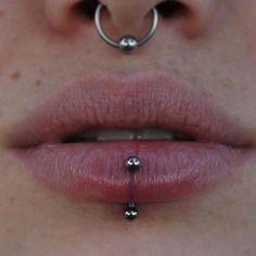 a woman with piercings on her lip and nose is shown from the bottom view