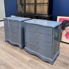 two blue dressers sitting next to each other on top of a hard wood floor