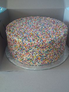 a cake in a box with sprinkles on it