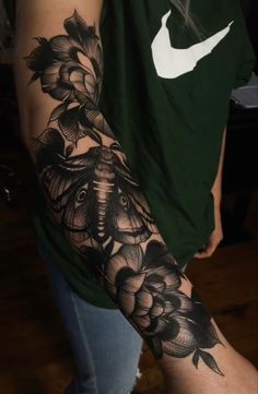 a person with a black and white tattoo on their arm