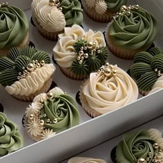 cupcakes with green and white frosting in a box