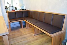 a wooden bench sitting in the middle of a room