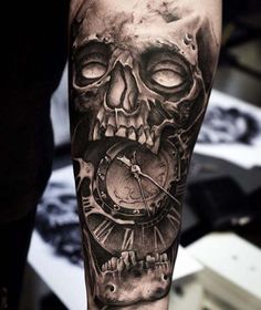 a man's arm with a clock and skull on it