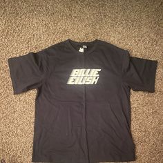 a black t - shirt with the word blue dust printed on it sitting on carpet