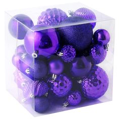 a clear box filled with purple christmas ornaments