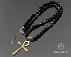 Brass Ankh Cross Necklace Natural Amethyst & Black Onyx Beaded Necklace Anger Gemstone Necklace Protective Necklace -ALL THE PRODUCTS AT ELISAJEWELRYART ARE HANDMADE AND MADE WITH NATURAL BEADS. -WHAT DOES THE ONYX STAND FOR    A powerful protection stone, Black Onyx absorbs and transforms negative energy, and helps to prevent the drain of personal energy. Black Onyx aids the development of emotional and physical strength and stamina, especially when support is needed during times of stress, con Spiritual Onyx Jewelry With Black Beads, Black Ankh Spiritual Jewelry, Black Ankh Jewelry For Gifts, Black Gemstone Beaded Necklace With Spiritual Style, Black Amethyst Gemstone Beads Necklace, Elegant Black Beads, Gems, And Cabochons For Gifts, Adjustable Ankh Black Necklace, Spiritual Black Beaded Gemstone Necklaces, Spiritual Onyx Necklace With Polished Beads