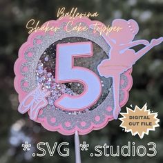 a pink and silver number five cake topper with a ballerina figure on it