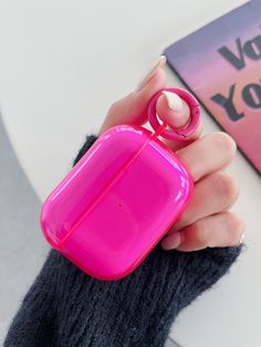 a person holding a pink object in their hand