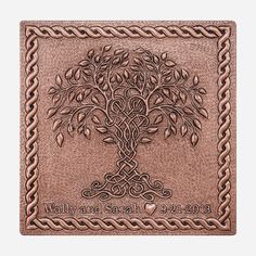 the celtic tree of life is engraved on an antique copper leather wallet with braiding around it