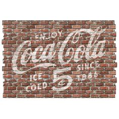 an old coca cola sign painted on a brick wall