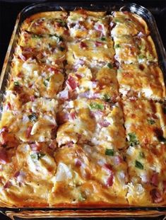 a casserole dish with meat, cheese and vegetables in it sitting on a stove