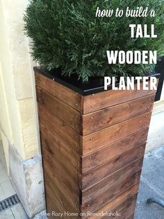 a tall wooden planter sitting next to a building