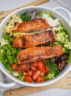 two salmons and vegetables in a white bowl