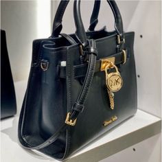 Brand New With Tag Color: Black Michael Kors Hamilton Small Satchel Shoulder Crossbody Bag Pebbled Leather Michael Kors Logo At Front Zip Top Closure Gold Toned Hardware Mk Key & Lock On Front Custom Mk Fabric Lining 1 Slip-In Pockets 1 Zipper Pocket 10" (L) X 8"(H) X 4"(D) Strap: 4", 18"- 24" Black Satchel With Turn-lock Closure And Double Handle, Black Bag With Turn-lock Closure And Double Handle, Black Bags With Double Handle And Turn-lock Closure, Black Double Handle Bag With Turn-lock Closure, Designer Black Bag With Turn-lock Closure, Tote Bag With Lock, Black Travel Bag With Lock, Black Bags With Turn-lock Closure For Daily Use, Black Bag With Turn-lock Closure For Daily Use