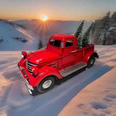 an old red truck with a christmas tree in the back is driving through deep snow