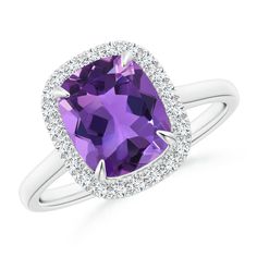 Crafted in cathedral style, this is an elegant cocktail ring in 14k white gold. The claw-set deep purple cushion amethyst is illuminated by a halo of several sparkling diamonds. Classic Purple Diamond Ring With Halo Setting, Cushion Cut Purple Amethyst Ring, Purple Cushion, Girls Ring, February Birthstone Jewelry, Amethyst Cathedral, Purple Cushions, Diamond Halo Ring, Gift For Her Birthday