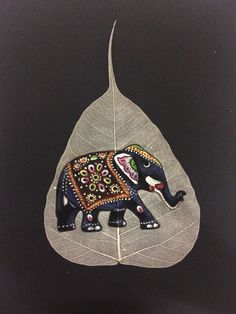 an elephant painted on top of a leaf