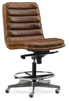 a brown leather office chair sitting on top of a metal base