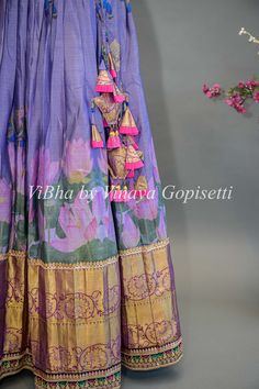 Indulge in the luxurious beauty of our Purple Floral Kanchi Silk Lehenga. With its intricately embroidered borders and delicate purple floral design, this lehenga is sure to make you the center of attention at any special occasion. Paired with a Kanchi Kalamkari Dupatta, experience an elegant fusion of traditional and modern styles. Bohemian Traditional Wear For Reception And Festivals, Bohemian Traditional Wear For Festival Receptions, Bohemian Traditional Wear For Receptions And Festivals, Designer Tussar Silk Choli With Motifs, Bohemian Dupatta With Motifs For Reception, Bohemian Traditional Wear With Motifs, Floor-length, Bohemian Floor-length Traditional Wear With Motifs, Purple Dupatta With Printed Border For Diwali, Bohemian Banarasi Silk Choli With Cutdana