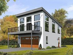 a three story house with two garages on the second floor and balcony above it