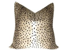 a cheetah print pillow with black spots on the front and back of it