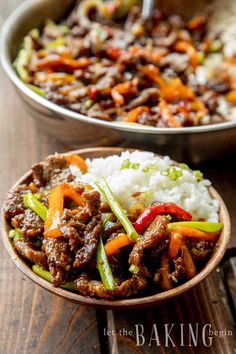 two bowls filled with meat and rice on top of a wooden table