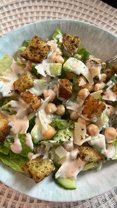 a white bowl filled with salad on top of a table