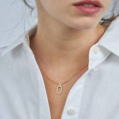 A gold chain and pendant, inspired by the interlinking of cufflinks, brings this necklace to life. As part of our Tailored Collection we studied all elements of suiting, and were fascinated by how a cufflink weaves itself through a button hole and connects to offer a practical yet beautiful finish. The oval pendant with diamond tracing hangs onto the chain with a hook that has a diamond at its center. The frame of the pendant measures 17mm and has 25 diamonds set within. If ordered in rose gold, the chain will be our Rollo chain. All features can be customized! Please contact us if you wish to make changes, we love making custom designs. All of our jewelry is carefully handmade in our atelier. *HC diamond are all conflict-free diamonds To order by phone 972-72-2991000 Gold Chain And Pendant, Chain And Pendant, Gold Chain With Pendant, Button Hole, Oval Pendant, White Diamonds, Conflict Free Diamonds, White Diamond, Diamond White