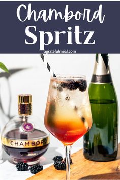 a close up of a drink in a wine glass with the words champagne spritz next to it