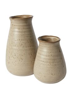 two ceramic vases sitting next to each other on a white background, one with brown speckles