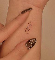 a woman's hand with a small tattoo on it