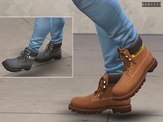 a pair of brown boots on top of a person's feet with blue pants