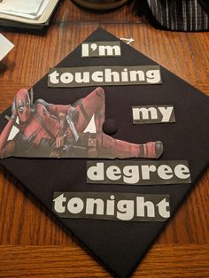 a graduation cap with the words i'm touching my degree tonight