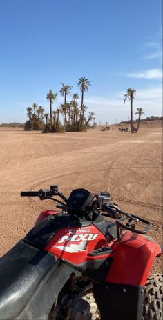 a red and black atv parked in the desert