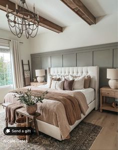 a bedroom with a large bed and chandelier hanging from it's ceiling