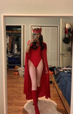 a woman in a red costume taking a selfie