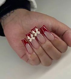 a woman's hand with some red and white nails