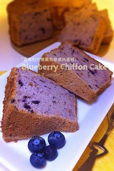 slices of blueberry chiffon cake on a white plate with fresh blueberries