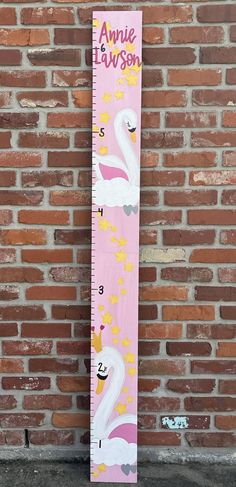 a pink growth chart with two white swans on it, and stars in the sky