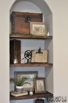 an old trunk is sitting on top of a shelf in the corner of a room