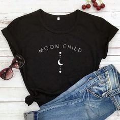 Stay magical in this Moon Child 100% Cotton T-shirt. This tee is not only comfortable but also trendy and perfect for showing off your spiritual side. Whether you're casting spells or just going about your day, this shirt is perfect for the modern witch. Size: S/M/L/XL/XXL/XXXL Black Tshirt Aesthetic, Spiritual Girl, Tshirt Aesthetic, Boho Festival Fashion, Modern Witch, Black Characters, Boho Festival, Moon Child, Kids Shorts